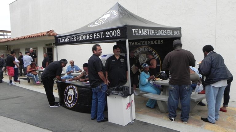 Members gathering around a Teamster Riders tent at a Local 848 event.